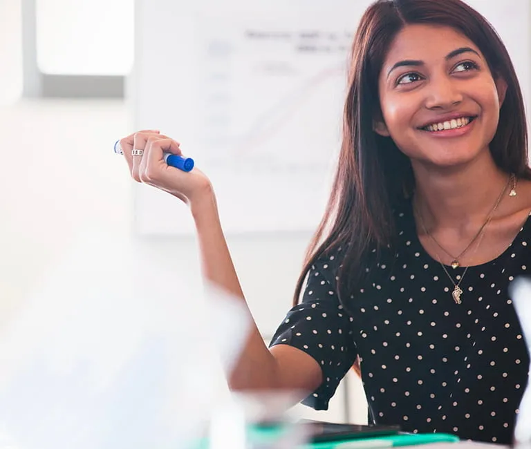 Woman holding a sharpie marker in a conference room