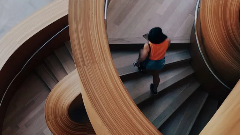 Woman walking up staircase